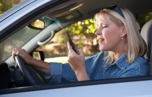 Woman Text Messaging on Her Cell Phone While Driving